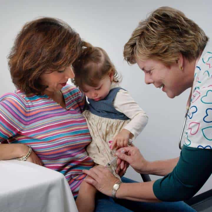 Primary Care doctor applying child vaccine