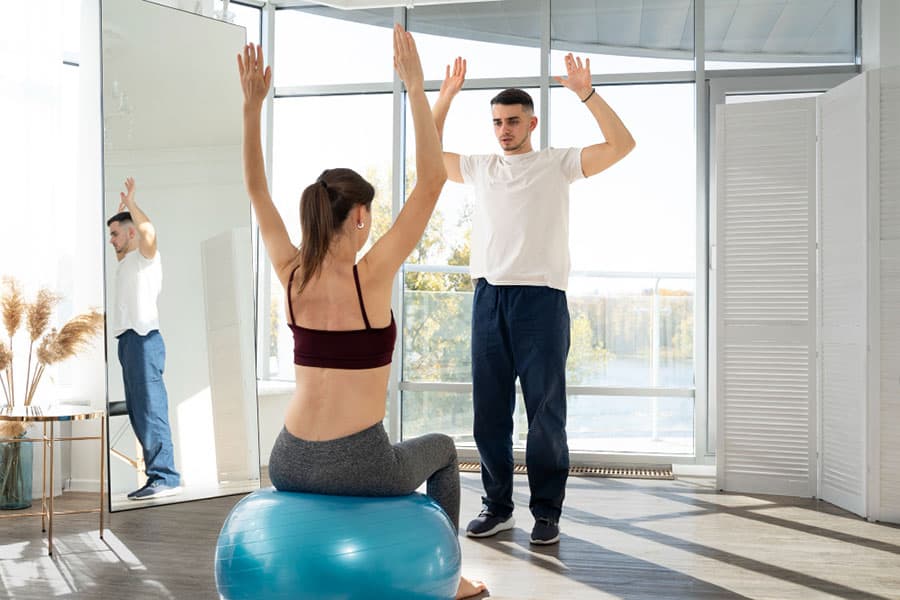 full-shot-woman-exercising-on-gym-ball-benefits-of-physical-therapy