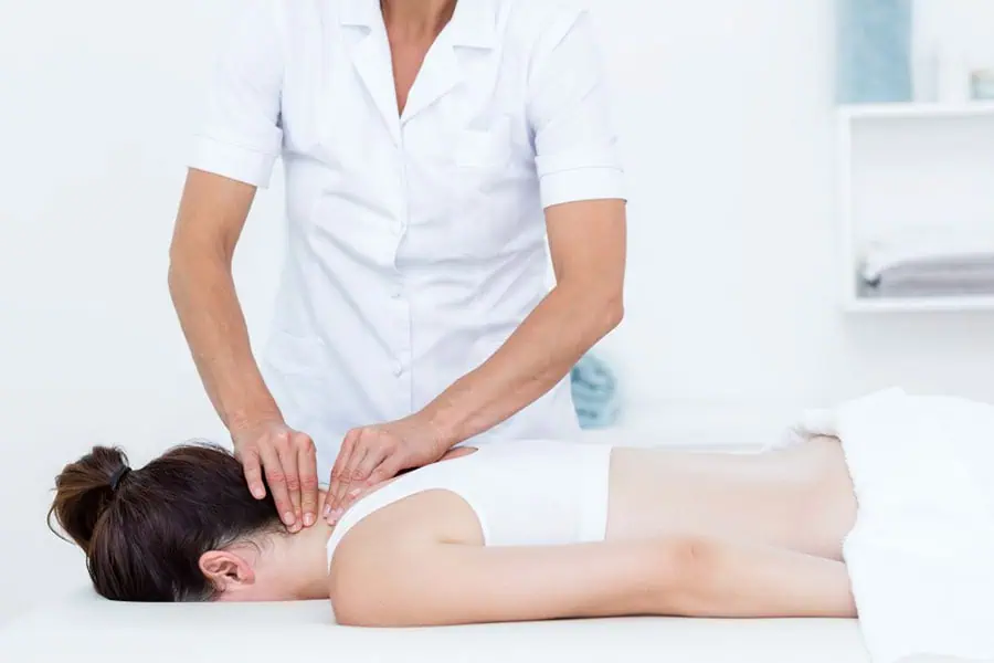 Professional performing medical massage on patient's upper neck for rehabilitation in Tampa
